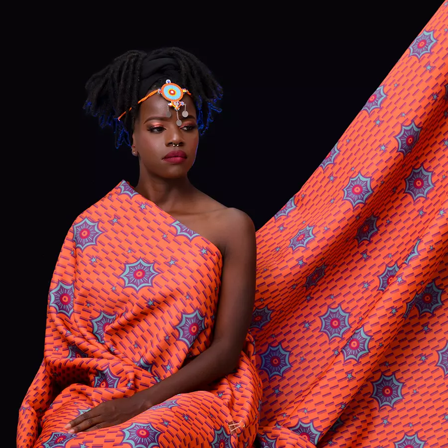 Akello wearing Afrikan Star Royals printed on Sparkle fabric. Designed by Nanjala Design